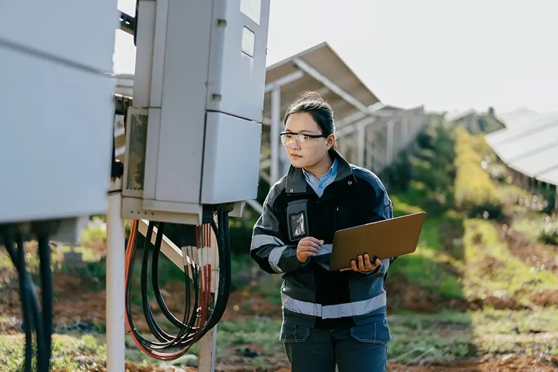 Asian female engineer working in solar power station