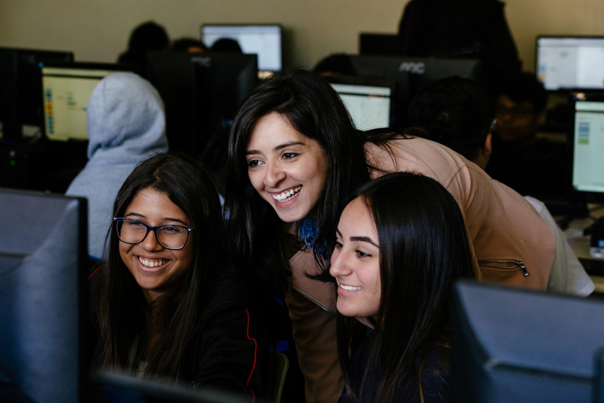 Three students use IBM SkillsBuild free learning in class